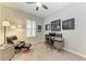 Bedroom with a workspace, comfortable seating, and natural light from a window at 13034 Bliss Loop, Bradenton, FL 34211