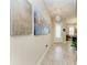 Elegant foyer showcasing tile floors, modern lighting, and artistic wall decor at 13034 Bliss Loop, Bradenton, FL 34211