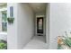 Inviting covered front entrance with elegant door, textured walls, and decorative plants at 13034 Bliss Loop, Bradenton, FL 34211