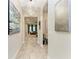 Bright hallway showcasing tile flooring and views into a living room and other spaces at 13034 Bliss Loop, Bradenton, FL 34211