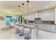 Modern kitchen with gray cabinets, granite countertops, stainless steel appliances, and a breakfast bar at 13034 Bliss Loop, Bradenton, FL 34211