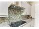 Gourmet kitchen featuring stainless steel appliances, granite counters, and stylish mosaic backsplash at 13034 Bliss Loop, Bradenton, FL 34211