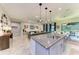 Spacious open-concept kitchen featuring granite countertops, pendant lighting, and an inviting dining area at 13034 Bliss Loop, Bradenton, FL 34211