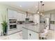 Modern kitchen with a large island, gray cabinets, stainless steel appliances, and a stylish backsplash at 13034 Bliss Loop, Bradenton, FL 34211