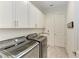Well-organized laundry room with modern washer and dryer, storage cabinets, and a convenient utility sink at 13034 Bliss Loop, Bradenton, FL 34211