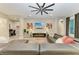 Bright living room showcases a gray leather sectional sofa, recessed lights, and contemporary decorations at 13034 Bliss Loop, Bradenton, FL 34211
