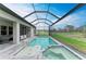 Resort-style pool and spa with a screened-in patio, lounge seating, and a serene backdrop of lush landscaping at 13034 Bliss Loop, Bradenton, FL 34211
