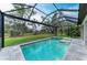 Enclosed pool and spa with an expansive screened patio, offering an outdoor entertaining space and picturesque views at 13034 Bliss Loop, Bradenton, FL 34211