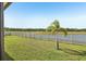 Wide view of backyard with a white fence and water views at 14413 Seattle Slew Ln, Ruskin, FL 33573
