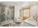 Bathroom with marble floors and a shower with glass doors at 14413 Seattle Slew Ln, Ruskin, FL 33573