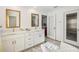 A stunning bathroom featuring double vanities and marble floors at 14413 Seattle Slew Ln, Ruskin, FL 33573