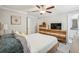 A bright bedroom with a ceiling fan and wooden furniture at 14413 Seattle Slew Ln, Ruskin, FL 33573