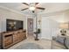 Well-lit bedroom featuring neutral colored walls and ceiling fan with a closet at 14413 Seattle Slew Ln, Ruskin, FL 33573