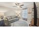 Comfortable bedroom featuring a ceiling fan, decorative curtains, and round stylish rug at 14413 Seattle Slew Ln, Ruskin, FL 33573