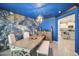 Dining room showcasing stylish decor, including a blue accent wall and modern chandelier at 14413 Seattle Slew Ln, Ruskin, FL 33573