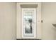 The front door is white with glass and tile work above the door frame at 14413 Seattle Slew Ln, Ruskin, FL 33573