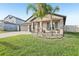 Charming single-story home featuring a three-car garage and a neatly manicured front lawn at 14413 Seattle Slew Ln, Ruskin, FL 33573