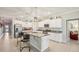 Bright kitchen featuring granite countertops, stainless steel appliances, and an island with bar stools at 14413 Seattle Slew Ln, Ruskin, FL 33573