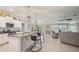 Modern kitchen open to the living area, featuring an island with bar seating at 14413 Seattle Slew Ln, Ruskin, FL 33573