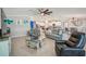 Open-concept living room with sofas, unique glass table, and easy access to the eat-in kitchen at 14413 Seattle Slew Ln, Ruskin, FL 33573