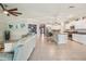 Bright open concept living space flows into the kitchen with eat-in dining and white cabinetry at 14413 Seattle Slew Ln, Ruskin, FL 33573