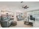 Spacious living room with open floor plan, ceiling fan, and tile flooring that connects to the kitchen at 14413 Seattle Slew Ln, Ruskin, FL 33573