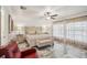 Bright main bedroom featuring a ceiling fan, marble-style floors, and lots of natural light at 14413 Seattle Slew Ln, Ruskin, FL 33573