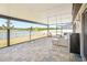 Expansive covered patio with outdoor seating, a mini refrigerator, and views of the backyard at 14413 Seattle Slew Ln, Ruskin, FL 33573
