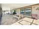 Expansive covered patio with outdoor seating, a picnic table, and views of the backyard at 14413 Seattle Slew Ln, Ruskin, FL 33573