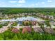 An aerial view showcasing the neighborhood homes surrounding the beautiful lake and fountain at 15045 Wind Whisper Dr, Odessa, FL 33556