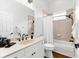 Clean bathroom with a white vanity, black hardware, and a shower-tub combination at 15045 Wind Whisper Dr, Odessa, FL 33556