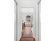 Hallway view of a primary bathroom featuring a soaking tub and beautiful arched window at 15045 Wind Whisper Dr, Odessa, FL 33556