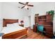 Inviting bedroom with wooden furniture, warm lighting, and comfortable decor at 15045 Wind Whisper Dr, Odessa, FL 33556