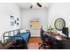 Bright bedroom featuring a twin bed, wood floors, desk, and natural light at 15045 Wind Whisper Dr, Odessa, FL 33556