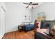 Simple bedroom with wood floors, a window view, and casual furniture at 15045 Wind Whisper Dr, Odessa, FL 33556