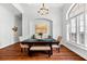 Dining room features a modern light fixture, an art niche, and a large window with plantation shutters at 15045 Wind Whisper Dr, Odessa, FL 33556