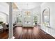 Bright foyer featuring high ceilings, hardwood floors, an elegant chandelier, and large windows with white trim at 15045 Wind Whisper Dr, Odessa, FL 33556