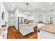Bright kitchen with granite countertops, an island with bar seating, stainless steel appliances, and white cabinets at 15045 Wind Whisper Dr, Odessa, FL 33556