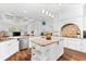 Spacious kitchen with stainless appliances, granite countertops, central island, breakfast bar and coffered ceilings at 15045 Wind Whisper Dr, Odessa, FL 33556