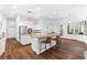 Bright kitchen with granite countertops, an island with bar seating, stainless steel appliances, and white cabinets at 15045 Wind Whisper Dr, Odessa, FL 33556