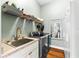 Efficient laundry room with modern washer/dryer, ample shelving, and a utility sink at 15045 Wind Whisper Dr, Odessa, FL 33556