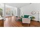An open living room with wood floors, high ceilings, neutral walls, and stylish green velvet furniture at 15045 Wind Whisper Dr, Odessa, FL 33556