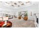 Spacious open-plan living room with kitchen, large windows, and seamless indoor-outdoor flow at 15045 Wind Whisper Dr, Odessa, FL 33556