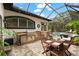 An outdoor kitchen and dining area next to the pool, perfect for grilling and entertaining at 15045 Wind Whisper Dr, Odessa, FL 33556