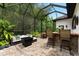 A screened patio with outdoor seating and a bar, perfect for relaxing and enjoying the backyard at 15045 Wind Whisper Dr, Odessa, FL 33556