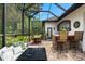 A screened patio with outdoor seating and a bar, great for enjoying the backyard and entertaining guests at 15045 Wind Whisper Dr, Odessa, FL 33556