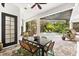 Covered outdoor patio area featuring a dining table and views of the screened pool at 15045 Wind Whisper Dr, Odessa, FL 33556