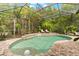Inviting screened pool with tropical landscaping creating a serene backyard oasis at 15045 Wind Whisper Dr, Odessa, FL 33556