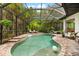 Sparkling pool inside screened enclosure with lounge chairs and tropical landscaping at 15045 Wind Whisper Dr, Odessa, FL 33556
