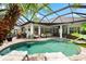 A beautiful screened-in pool area with a bar and outdoor seating, perfect for relaxing and entertaining at 15045 Wind Whisper Dr, Odessa, FL 33556